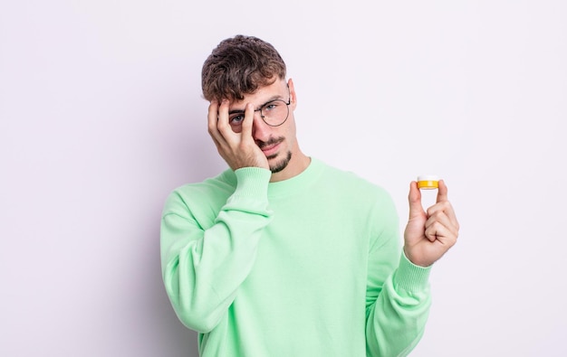 Young handsome man feeling bored, frustrated and sleepy after a tiresome. contact lenses