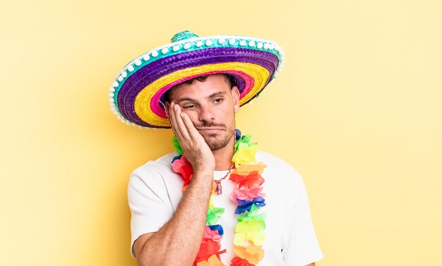 Young handsome man feeling bored, frustrated and sleepy after a tiresome. mexican party concept