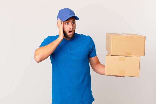 Young handsome man feeling happy, excited and surprised. package delivering concept