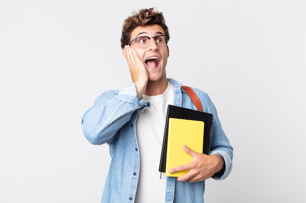 Young handsome man feeling happy, excited and surprised. university student concept