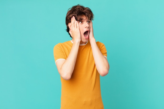 Young handsome man feeling happy, excited and surprised