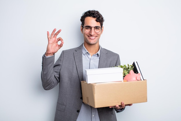 Young handsome man feeling happy, showing approval with okay gesture dismissal concept