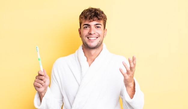 Young handsome man feeling happy, surprised realizing a solution or idea. toothbrush concept