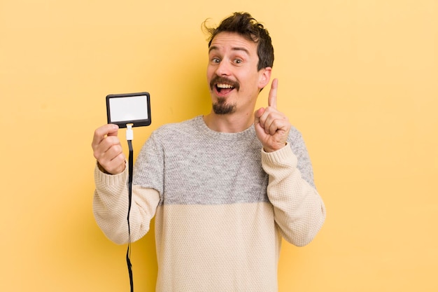 Young handsome man feeling like a happy and excited genius after realizing an idea vip pass id