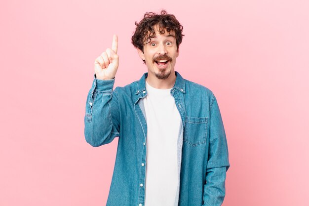 Young handsome man feeling like a happy and excited genius after realizing an idea