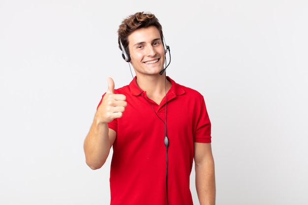 Young handsome man feeling proud,smiling positively with thumbs up. telemarketer concept