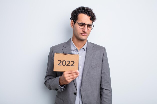 Young handsome man feeling sad, upset or angry and looking to the side. calendar concept