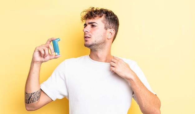 Young handsome man feeling stressed, anxious, tired and frustrated. asthma concept