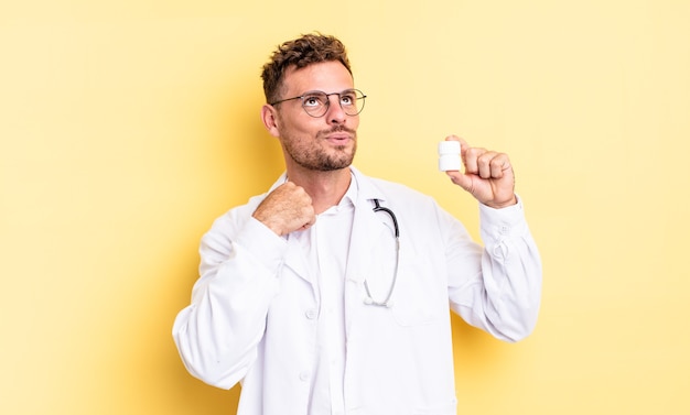 young handsome man feeling stressed, anxious, tired and frustrated. physician pills bottle concept