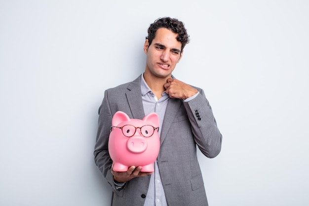 Young handsome man feeling stressed anxious tired and frustrated piggy bank concept