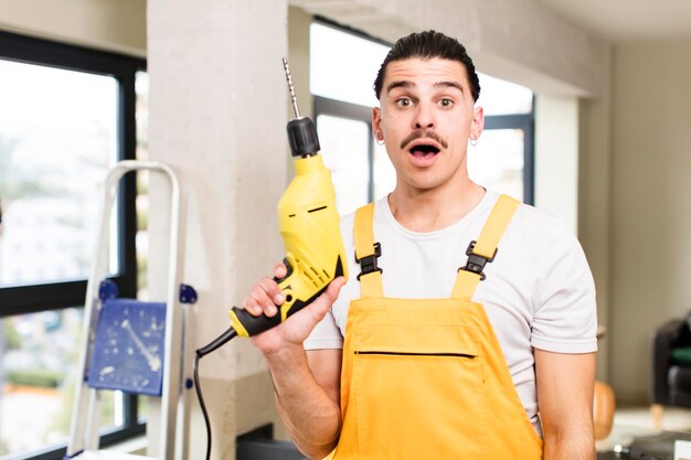 Young handsome man handyman or housekeeper concept at home interior