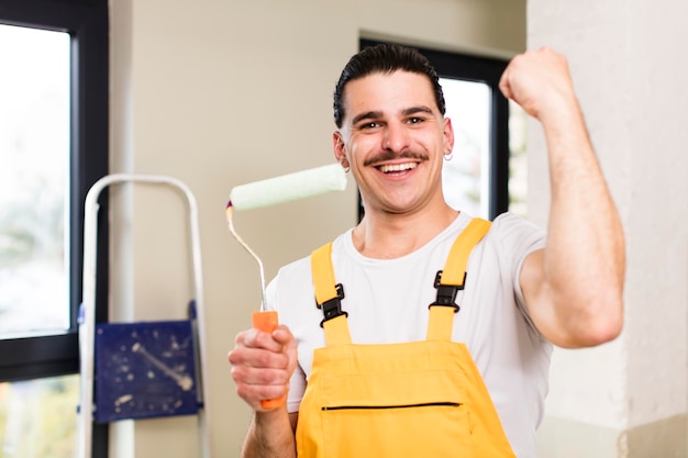 Young handsome man handyman or housekeeper concept at home interior