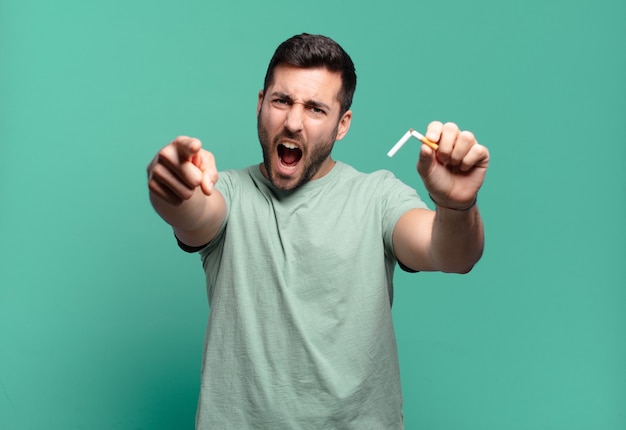 Young handsome man holding a cigarette. quit smoking concept