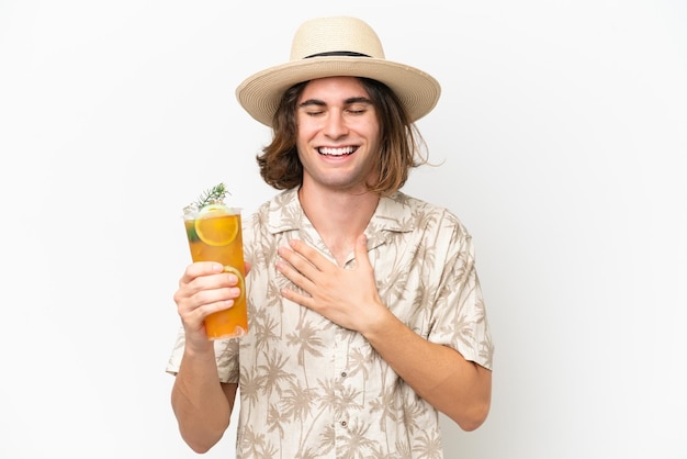 Young handsome man holding a cocktail isolated on white background smiling a lot