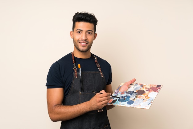 Young handsome man holding a palette