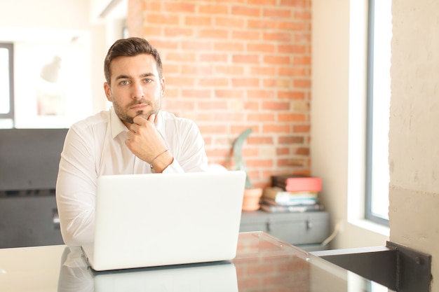 Young handsome man at home using a laptop