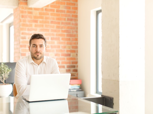 Young handsome man at home using a laptop