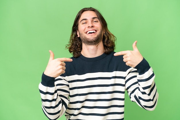 Young handsome man over isolated background proud and selfsatisfied