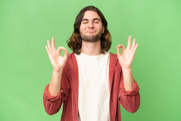 Young handsome man over isolated background in zen pose