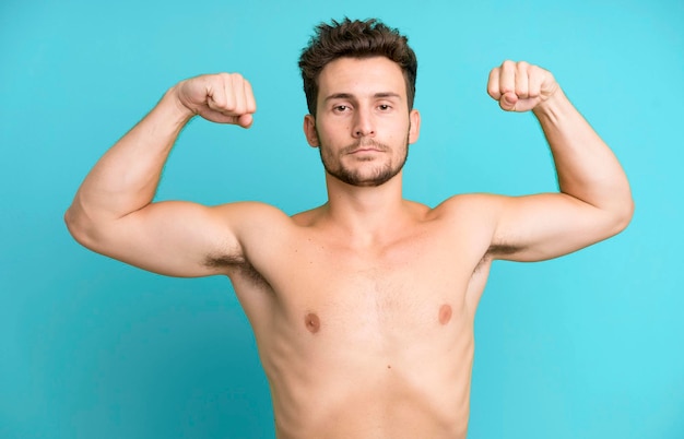 Young handsome man isolated strong body concept