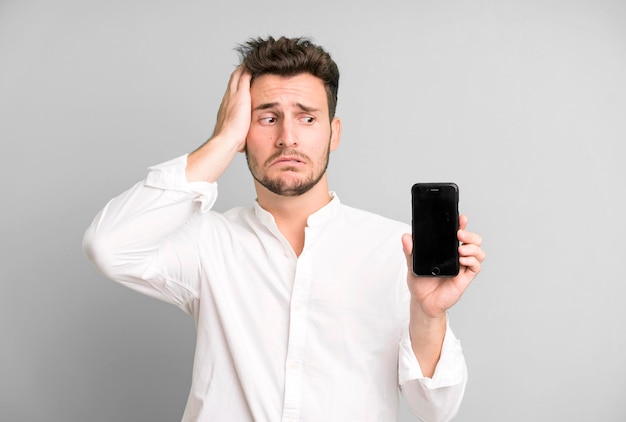 Young handsome man isolated using his telephone