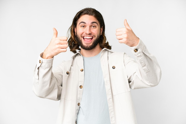 Young handsome man over isolated white background giving a thumbs up gesture