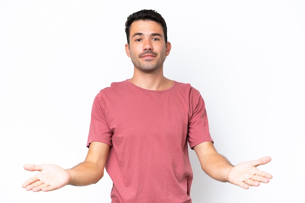 Young handsome man over isolated white background having doubts