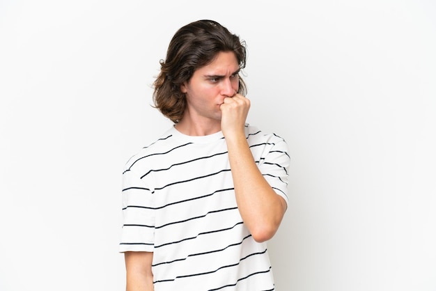 Young handsome man isolated on white background having doubts