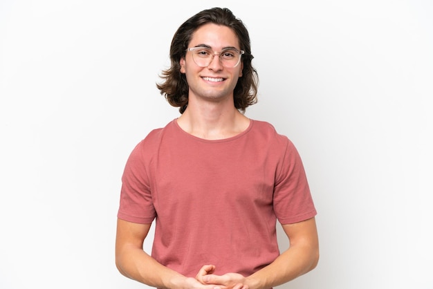 Young handsome man isolated on white background laughing