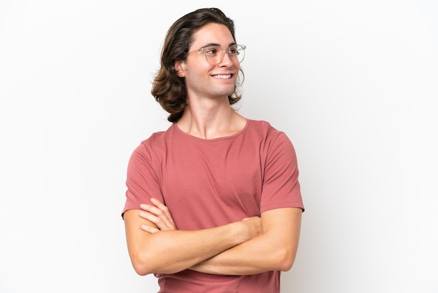 Young handsome man isolated on white background looking to the side and smiling