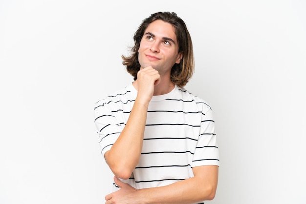 Young handsome man isolated on white background and looking up