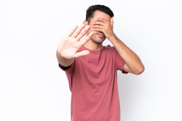 Young handsome man over isolated white background making stop gesture and covering face