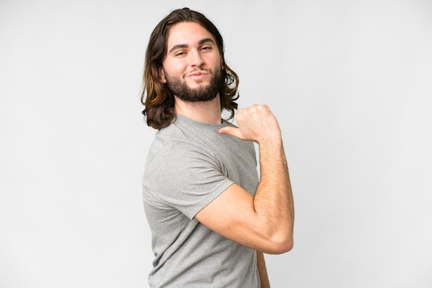 Young handsome man over isolated white background proud and selfsatisfied