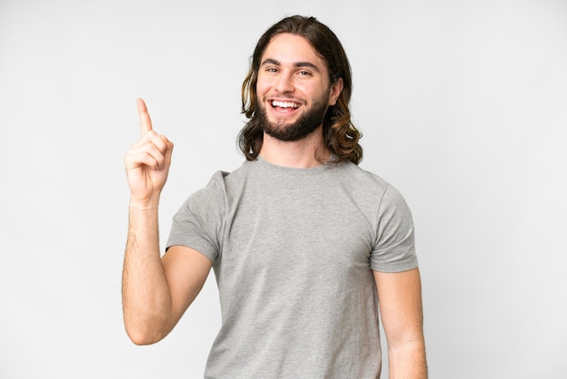 Young handsome man over isolated white background showing and lifting a finger in sign of the best