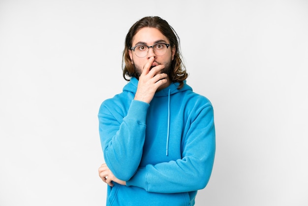 Young handsome man over isolated white background surprised and shocked while looking right