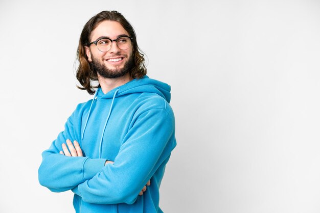 Young handsome man over isolated white background with arms crossed and happy