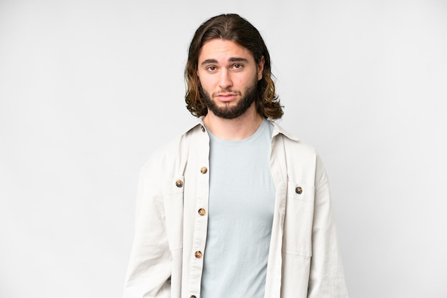 Photo young handsome man over isolated white background with sad expression