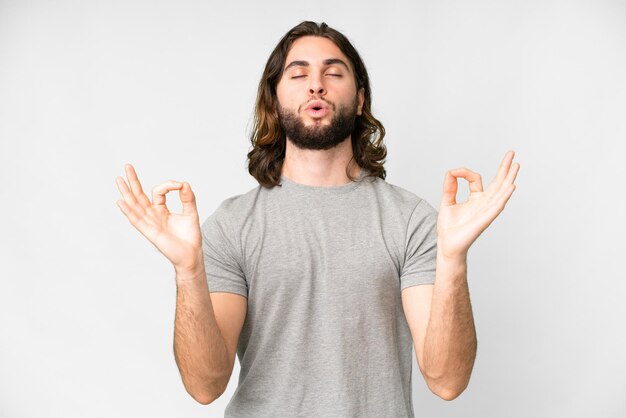 Young handsome man over isolated white background in zen pose