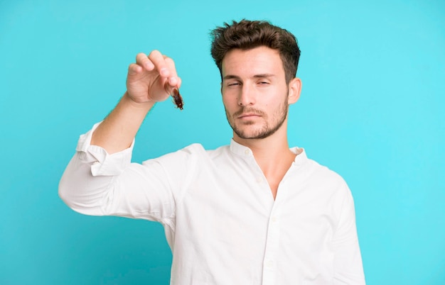 Young handsome man isolated with cockroachs