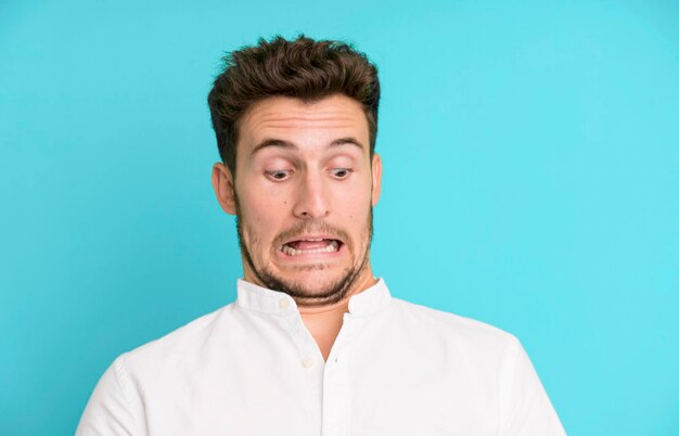 Young handsome man isolated with cockroachs