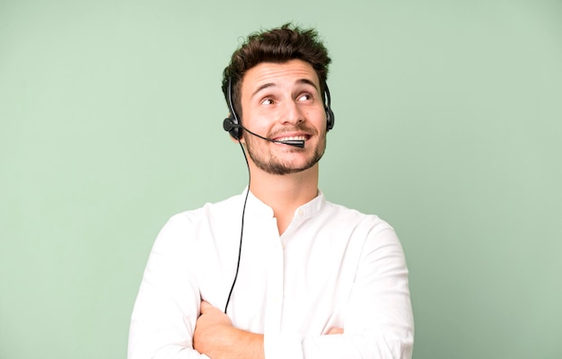 Young handsome man isolated with operator headphones and micro telemarketing concept