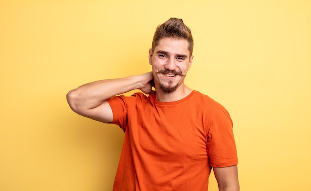 Young handsome man laughing cheerfully and confidently with a casual, happy, friendly smile. strange moustache concept