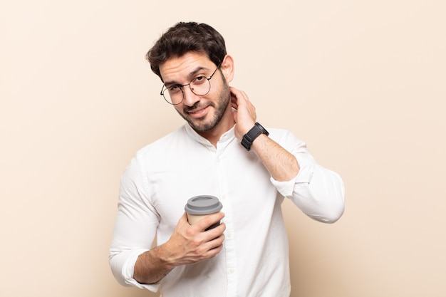 Young handsome man laughing cheerfully and confidently with a casual, happy, friendly smile