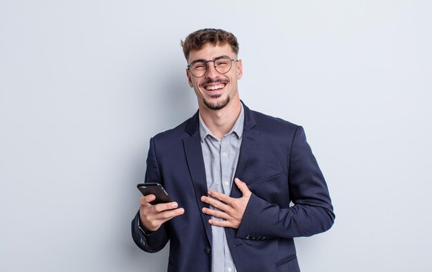 Young handsome man laughing out loud at some hilarious joke. business concept