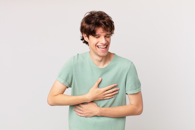 Young handsome man laughing out loud at some hilarious joke