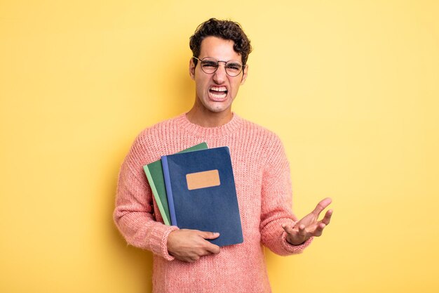 Young handsome man looking angry, annoyed and frustrated. notebook concept