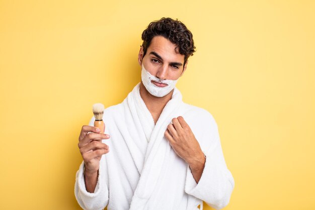 Young handsome man looking arrogant, successful, positive and proud. shaving and foam concept