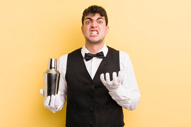 Young handsome man looking desperate frustrated and stressed bartender cocktail