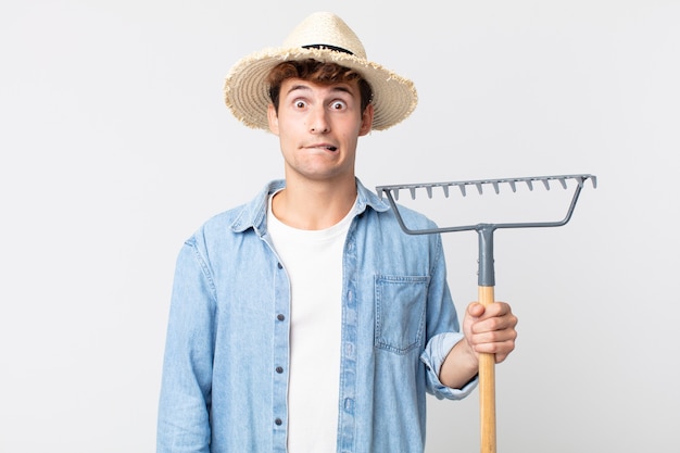 Young handsome man looking puzzled and confused. farmer concept