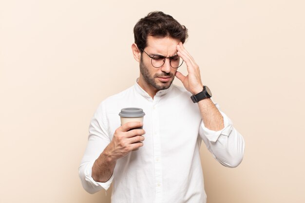 Young handsome man looking stressed and frustrated